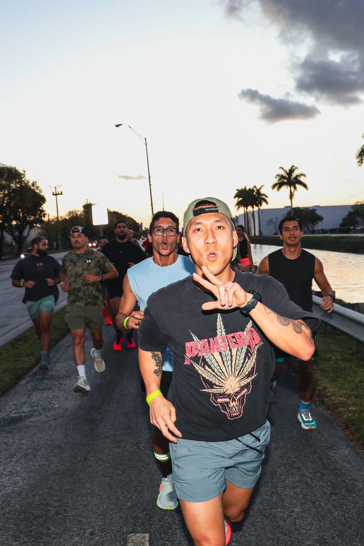 Runner giving a peace sign mid-run